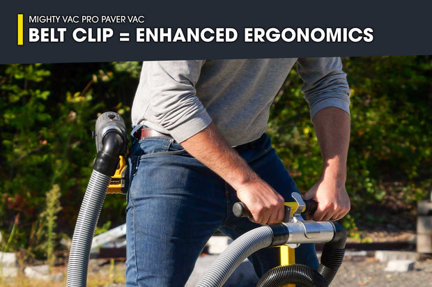 Person using a Mighty Vac Pro Paver Vac with a belt clip for enhanced ergonomics, outdoors.
