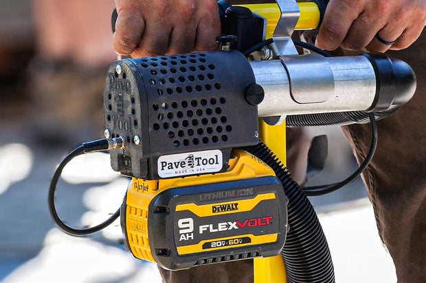 Paver vacuum held by a person with a blurred background