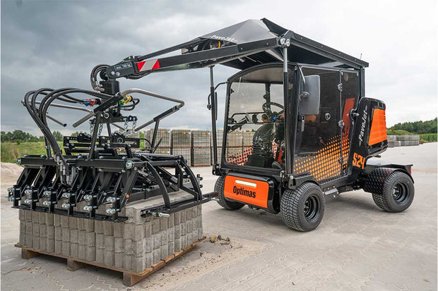 An orange and black S24 PaveJet paver laying machine with a black cabin, mounted on a construction vehicle.