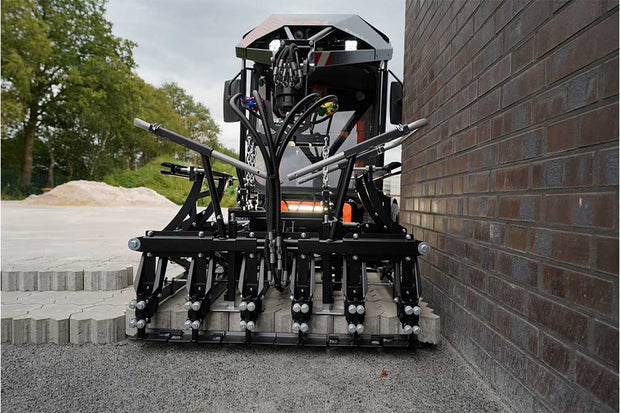 An orange and black S24 PaveJet paver laying machine laying pavers