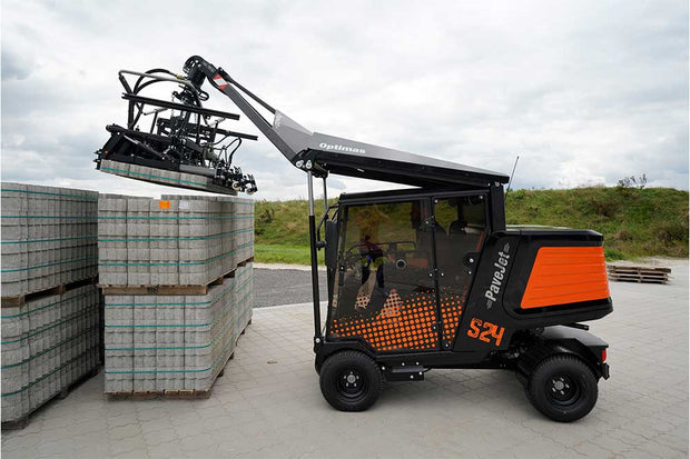 An orange and black S24 PaveJet paver laying machine laying pavers